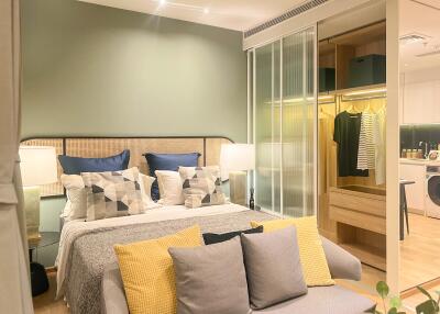 Modern bedroom with large bed, stylish decor, and adjoining closet