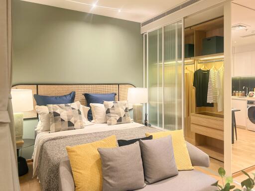 Modern bedroom with large bed, stylish decor, and adjoining closet