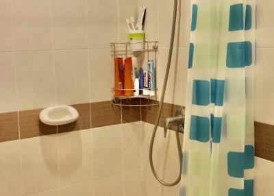 Bathroom with shower and blue patterned curtain