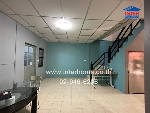 Main living area with staircase and dining table