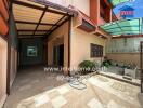 covered patio area in the backyard of a house