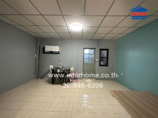 Spacious living room with tiled flooring and dining area