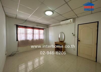 Bedroom with window, vanity table, and air conditioner