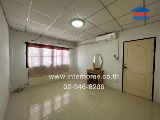 Bedroom with window, vanity table, and air conditioner