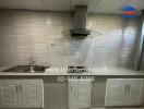 Kitchen with modern appliances and tiled backsplash