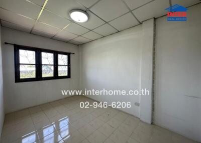 Bright bedroom with tiled floor and large window