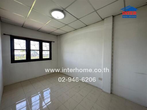 Bright bedroom with tiled floor and large window