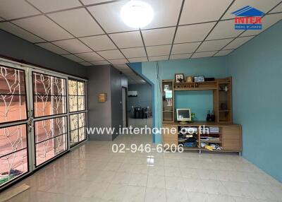 Spacious living room with tiled floor and built-in shelving