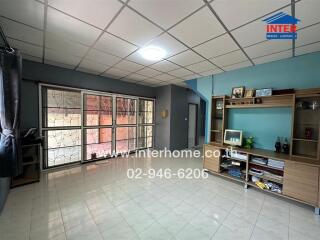 Spacious living room with large windows and built-in shelves