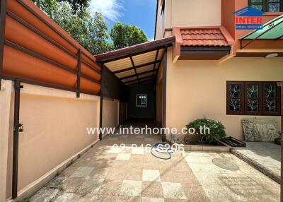 Covered walkway leading to the entrance of a house