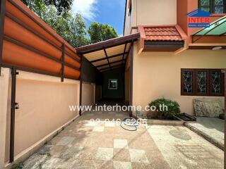 Covered walkway leading to the entrance of a house