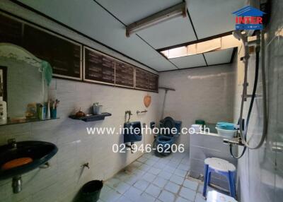 Bathroom with various sanitation fixtures and storage