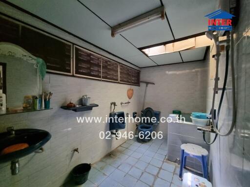 Bathroom with various sanitation fixtures and storage