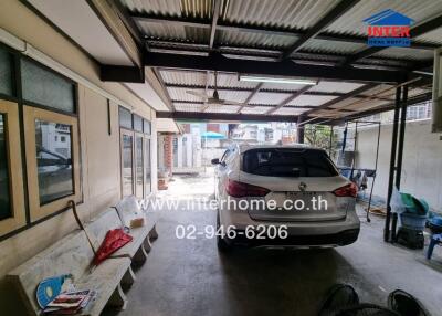 Covered garage with parked car