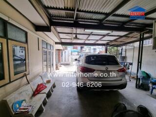 Covered garage with parked car