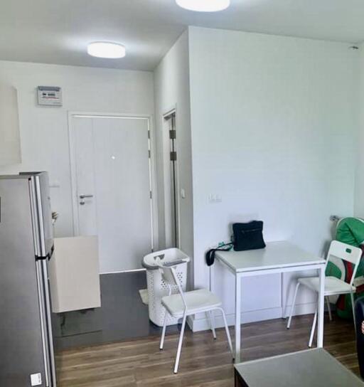 Small kitchen area with white furniture and appliances