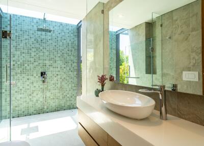 Modern bathroom with glass shower and vessel sink