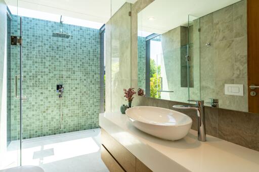 Modern bathroom with glass shower and vessel sink