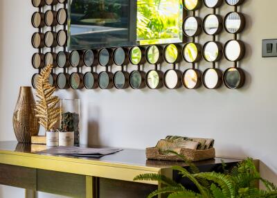 Stylish entryway with decorative mirror, console table, and indoor plants