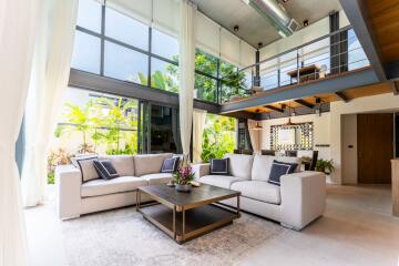 Spacious modern living room with large windows and a loft area