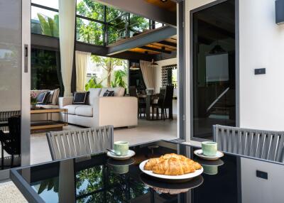 Contemporary open-plan living and dining area with glass walls