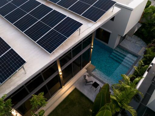 Modern building with solar panels and pool