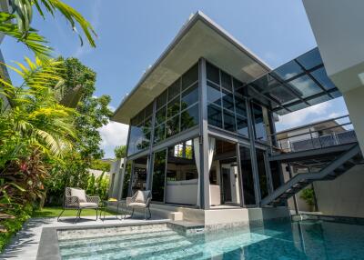 Modern multi-story house with a patio and swimming pool