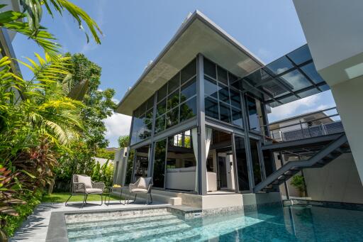 Modern multi-story house with a patio and swimming pool