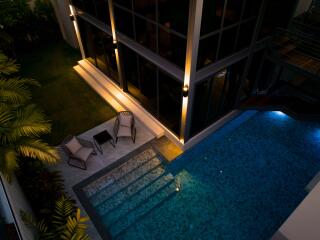 Modern outdoor area with poolside seating and pool