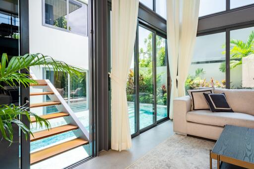 Modern living room with large windows overlooking a pool