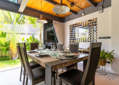 Modern dining room with wooden ceiling and large windows