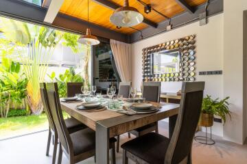 Modern dining room with wooden ceiling and large windows