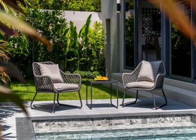 Modern outdoor seating area by a pool