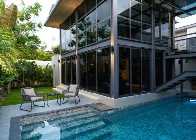 Modern two-story house with glass façade and private swimming pool