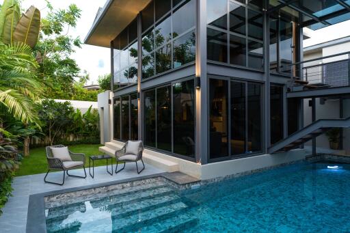 Modern two-story house with glass façade and private swimming pool