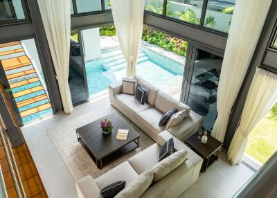 Modern living room with large windows and pool view