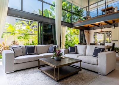 Modern living room with large windows and loft area