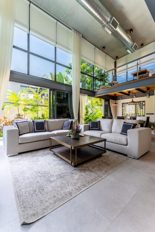 Modern living room with large windows and loft area