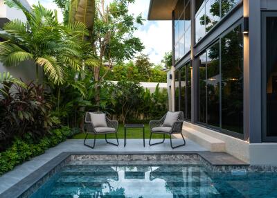 Modern outdoor seating area by a swimming pool