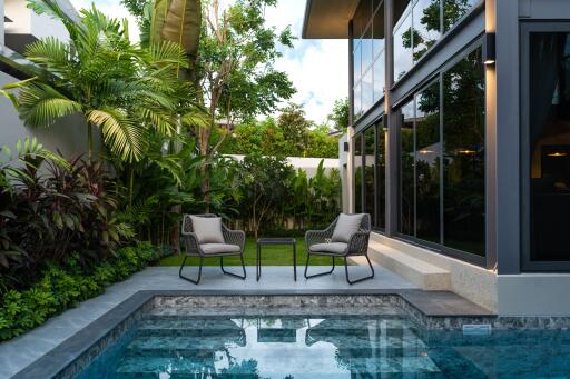 Modern outdoor seating area by a swimming pool