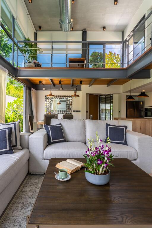 Modern living room with high ceilings and loft area