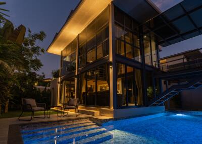 Modern house exterior with pool at night