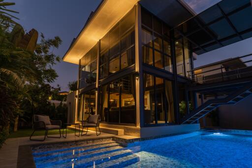 Modern house exterior with pool at night