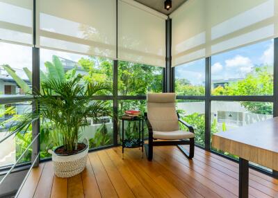 Bright sunroom with large windows and plants