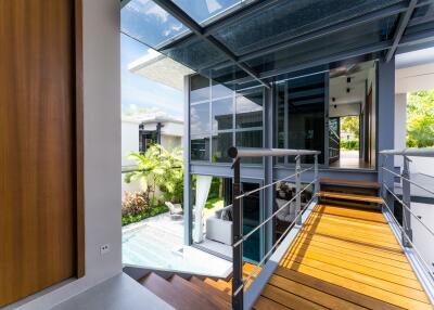 Modern building exterior with glass walls and wooden walkway