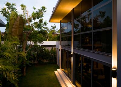 Modern house exterior with large windows and garden