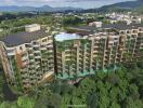 Arial view of a modern residential building surrounded by greenery with a rooftop pool