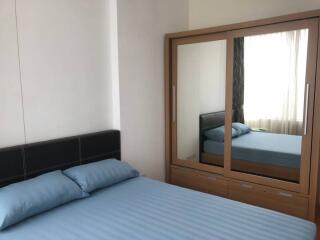 Bedroom with bed and mirrored wardrobe