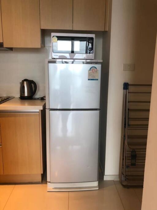 Kitchen with refrigerator and microwave