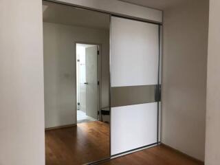 Bedroom with sliding closet doors and wooden flooring